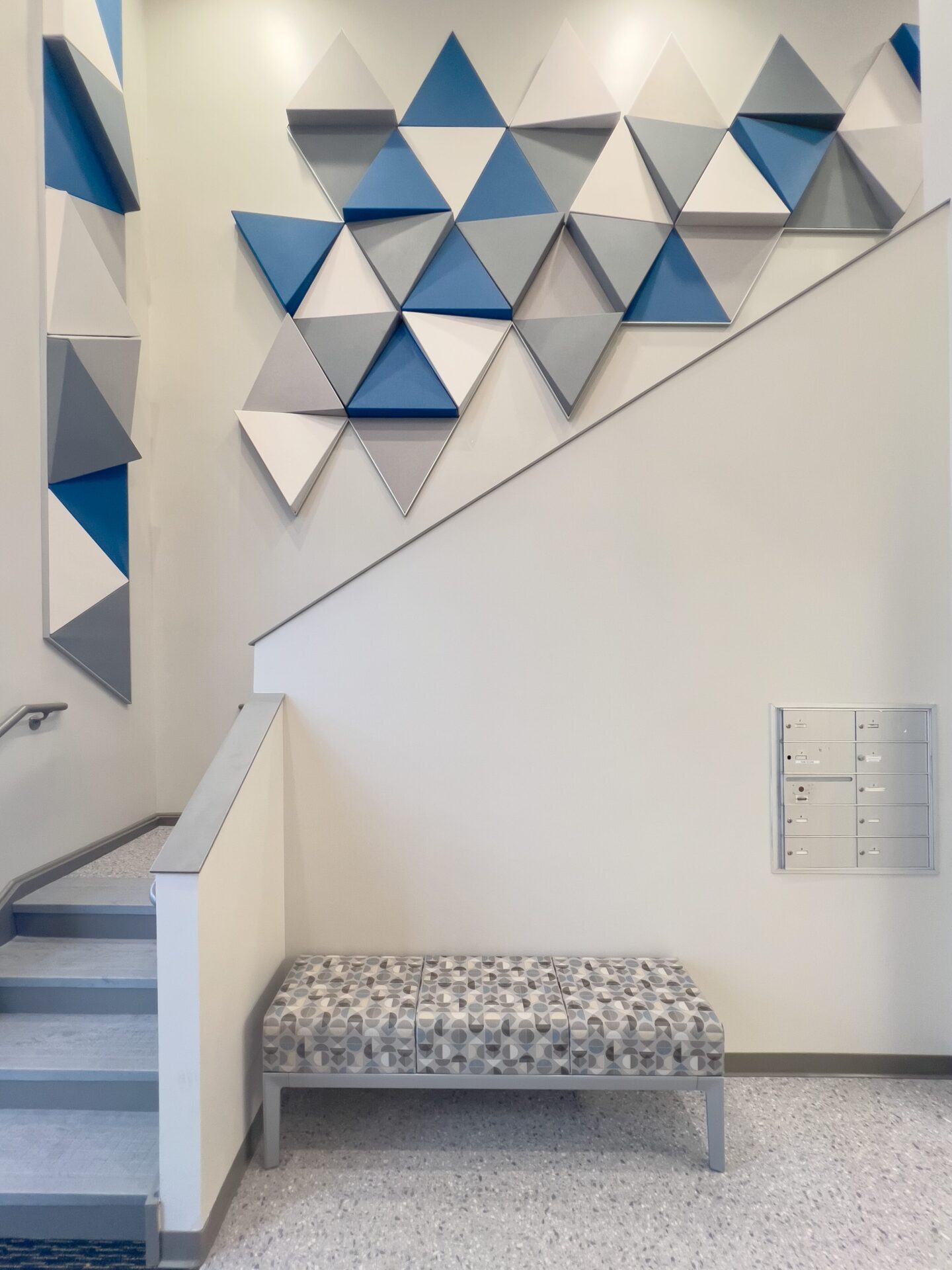 Dimensional Artofix acoustic wall tiles beside the medical office staircase